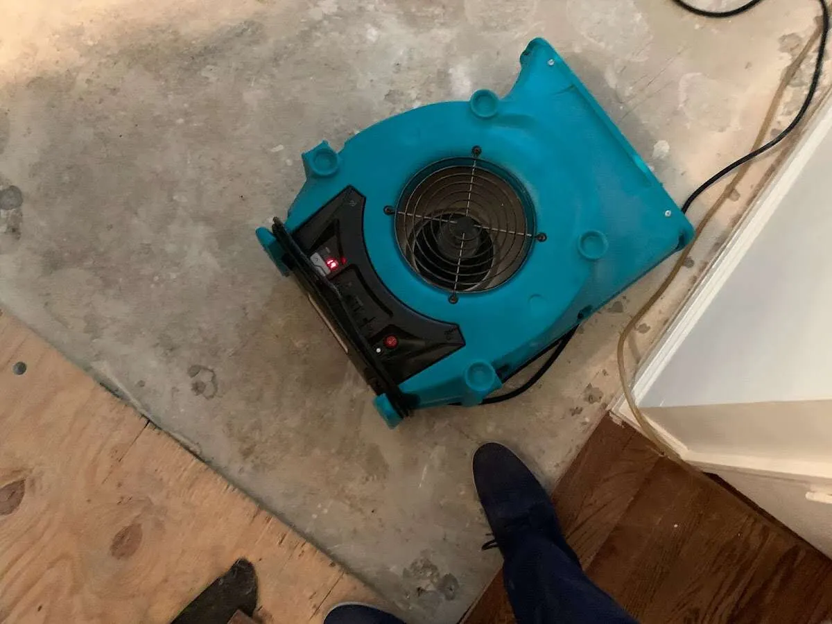 Air mover drying subfloor during Leak Detection & Repair in Wheeling